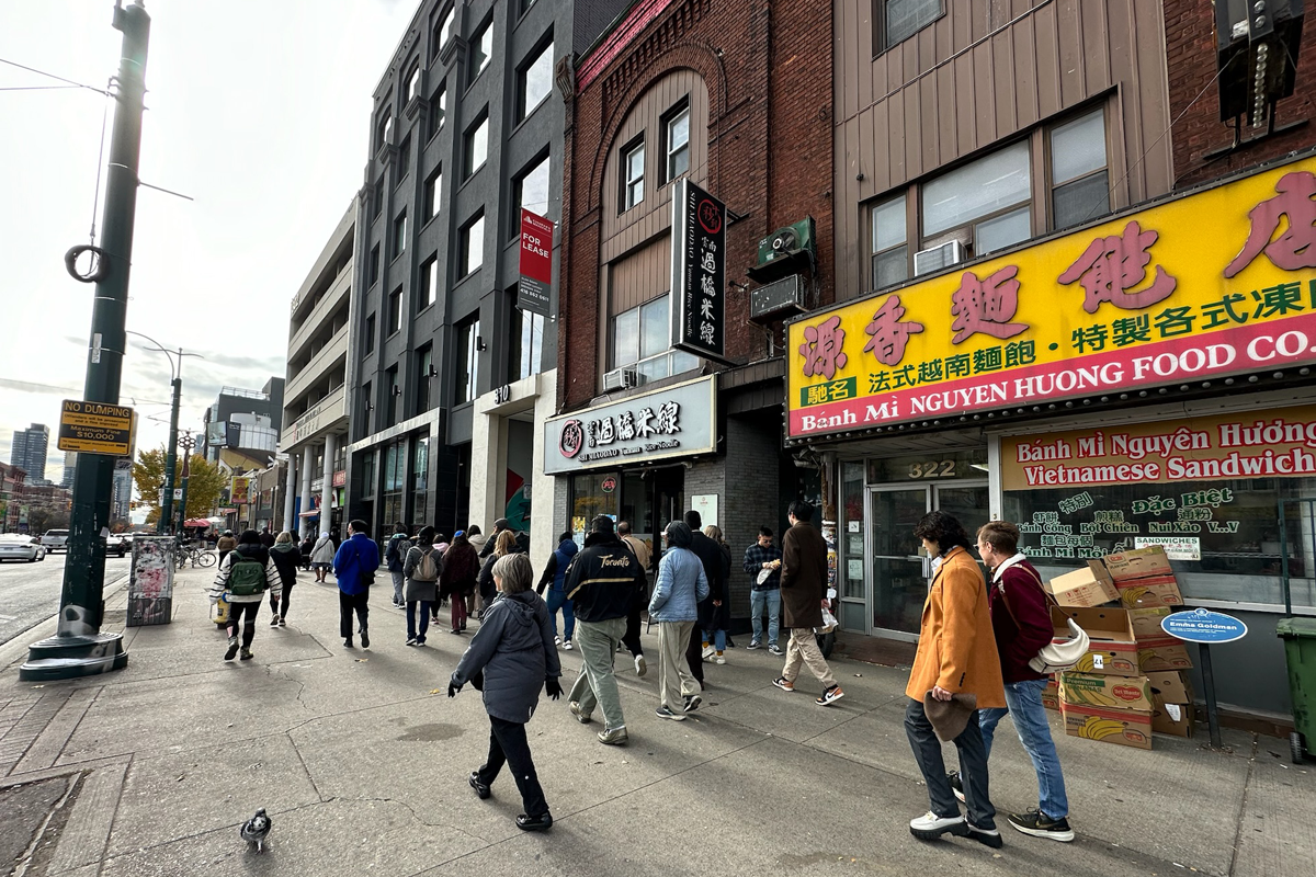 Group of people walking in Chinatown, Toronto.